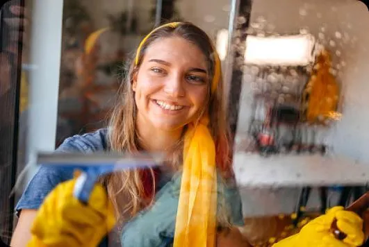 Woman with cleaning bottles